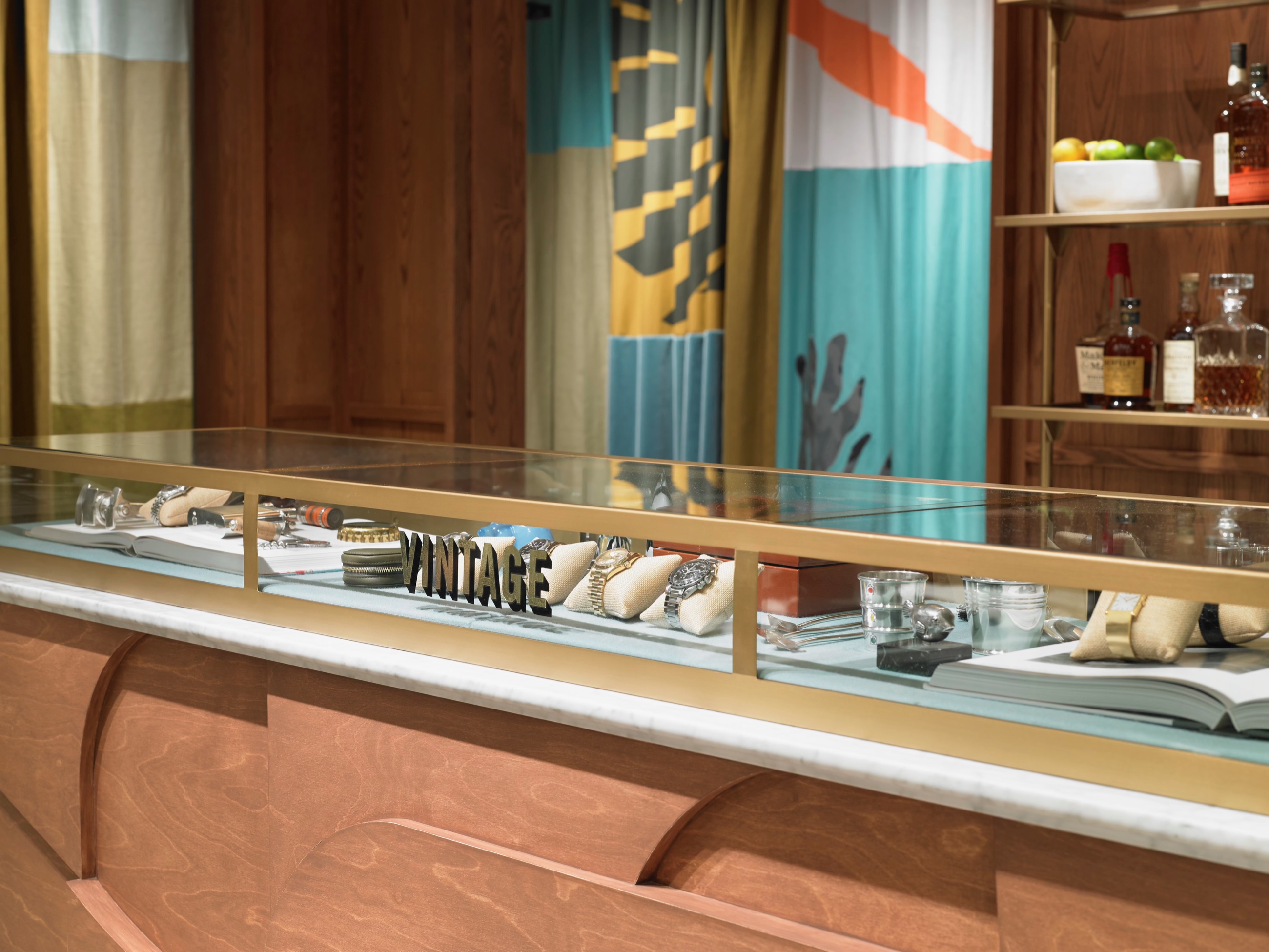 Detailed view of a brass and wood display case at Todd Snyder